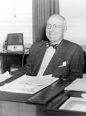 Home: Cannon Foundation - Charles A Cannon sitting at a desk